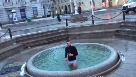 Guy black shirt in water fountain