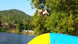 Huge launch off of inflatable raft back flop fail lake