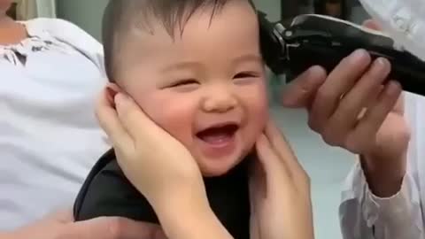 The most beautiful laugh of a child at the barber