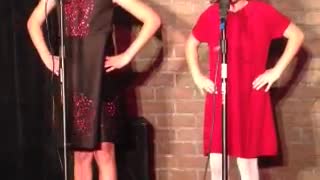Little Girl Shoves Sister Off Stage While Performing Song About Sisters