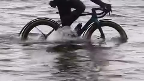 Beautifully ridding bicycle in water