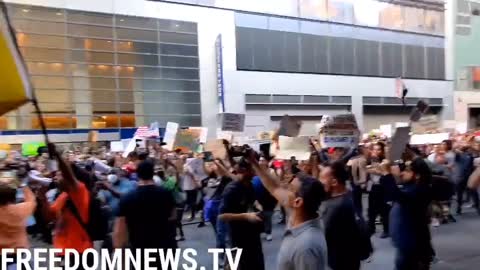 Protesters against vaccine mandates chant "Defund the Media" in front of the New York Times building