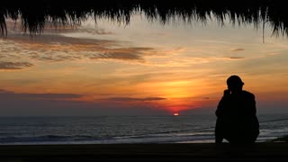 Alone Man Watching a Sunset at a Tropical Beach [Free Stock Video Footage Clips]