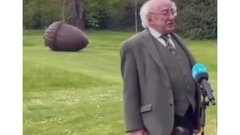 The President of Ireland and his dog who wants attention during interview.