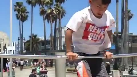 Kid Performs Stunts on Bars