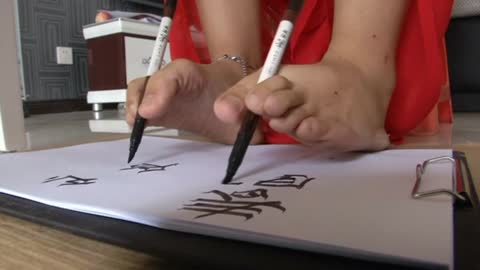 Woman writes with hands and feet simultaneously