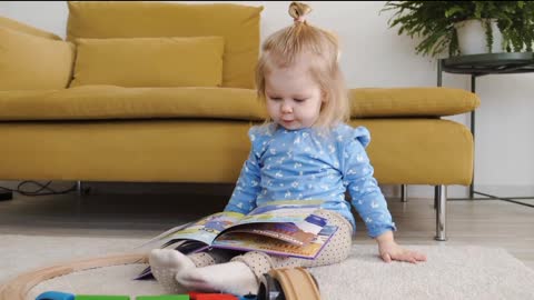 Cute baby girl playing with her Toy's