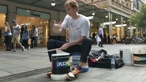 Boy showing his drum skills on streets