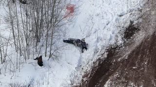 Hill Climber Trying to Stop Tumbling Snowmobile Gets Beat Up