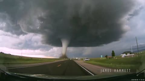 Storm chasing dashcam: Tornado crossing the highway! Laramie, Wyoming