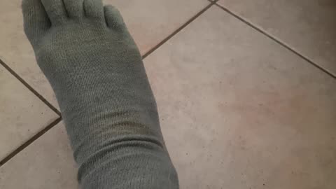 right foot with grey socks five fingers