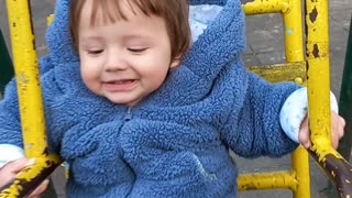 1 year old baby having fun in the park