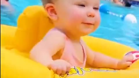 Cute baby dancing on the pool