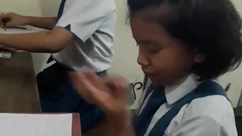 Deaf girl praying before writing exam.