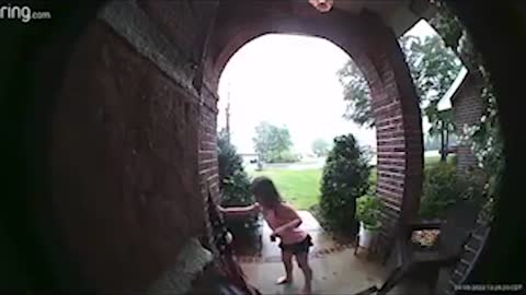 Little Girl Picks Up Flag After a Storm Knocked It Down