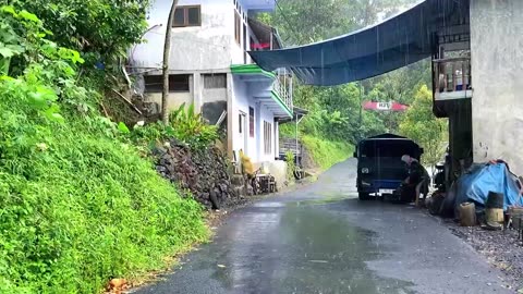 Rain in the mountain slope village__a beautiful but quite steep village__Indonesian village.