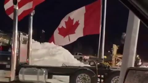 American & Canadian Truckers Fly Flags High & Proud Together in Protest