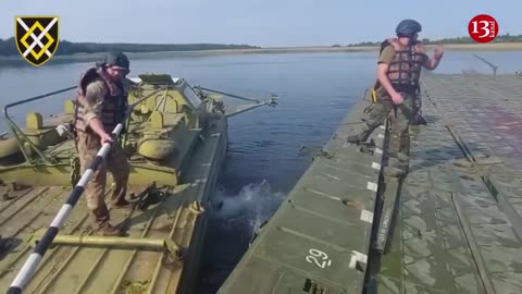 Ukrainian army prepares for attack by moving heavy equipment across river with pontoon bridges