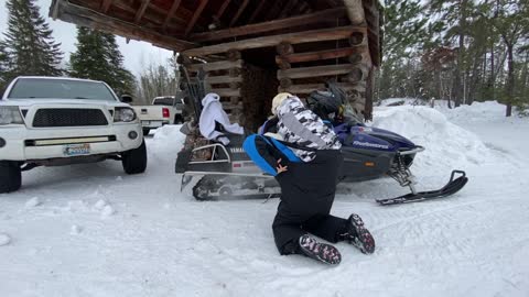 Dog Gets Ready to Ride Piggyback on Snow Mobile