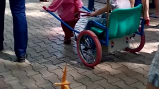 Kid Rides in a Minnie Mouse Sled