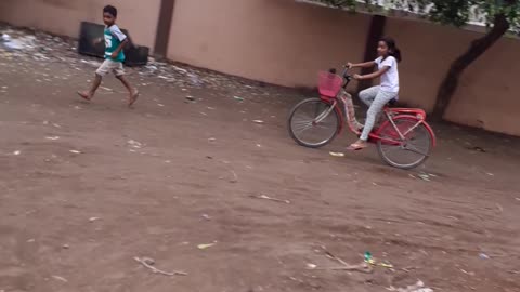 Boy chasing bycycle girl.