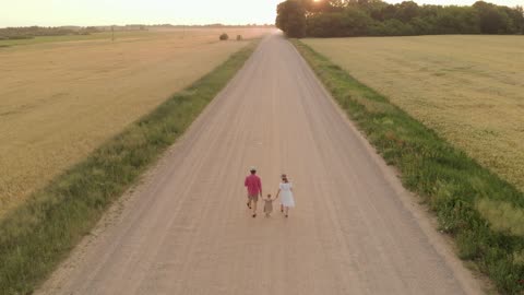 Drone Footage Of Family Walking On Dirt Road
