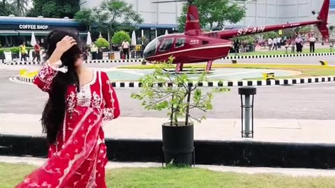 A beautiful girl beside helicopter