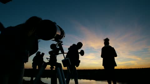 Friends stargazing together at night