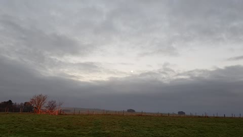 Sun is setting on a field in Avebury