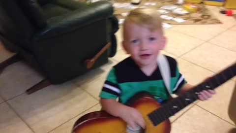 Toddler plays guitar and sings to Florida Georgia Line H.O.L.Y.
