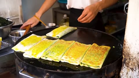 Chinese Street Food -Fried noodles with egg fried rice, fried broiler, egg and vegetable pie