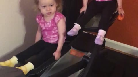 Twin girls take over elliptical machine