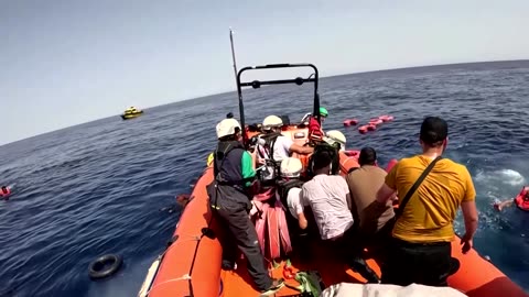 Video shows rescue of dozens of migrants at sea