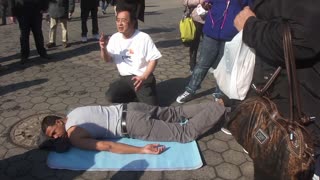 Luodong Massages Black Man On Sidewalk