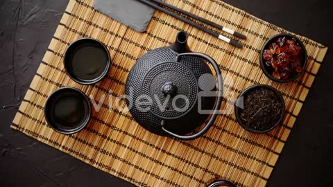 Asian green tea set on bamboo mat