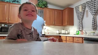 Child cooking show making chili with dad