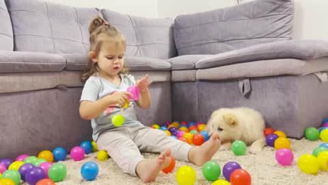 Cute_Baby_and_Puppy_Playing_With_Colored_Balls
