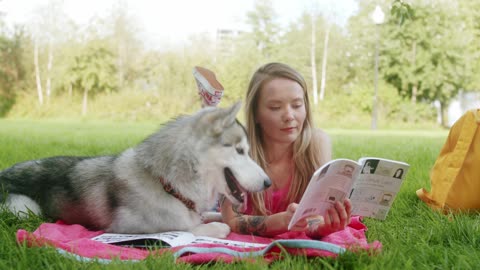 Playing with dog while reading a book