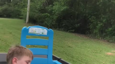 Tuckered Toddler Nods Off During Lawnmower Ride