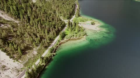 aerial view of lago del predil lake surrounded by hills in itally