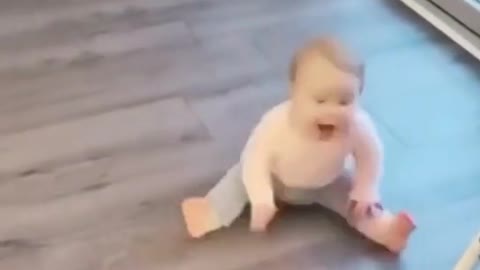 cute and adorable baby dancing on the floor