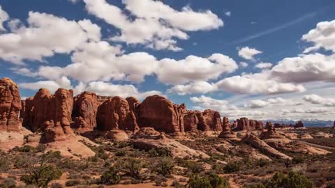 Clouds moving over rocky desert timelapse