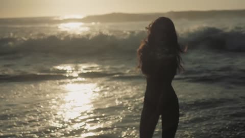 Woman walking into the ocean