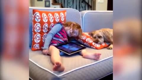 Little girl having a hard time staying awake, gets a wakeup call from family dog.