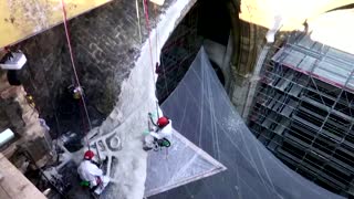 Macron scales Notre-Dame's rooftop