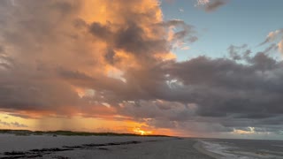 Beautiful storm clouds with the sunrise at the beach