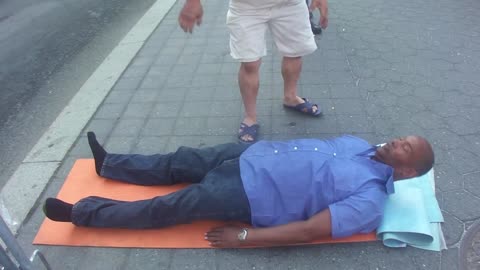 Luodong Briefly Massages Black Man In Purple Shirt On Sidewalk