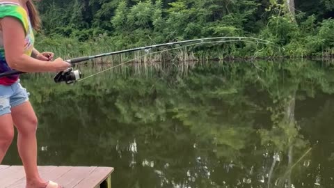 Woman Catches Catfish After It Takes Off With Her Fishing Pole