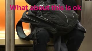 Guy all black wearing glasses shaving on subway