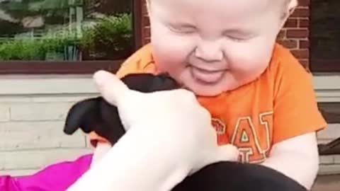 Baby first kiss with puppy
